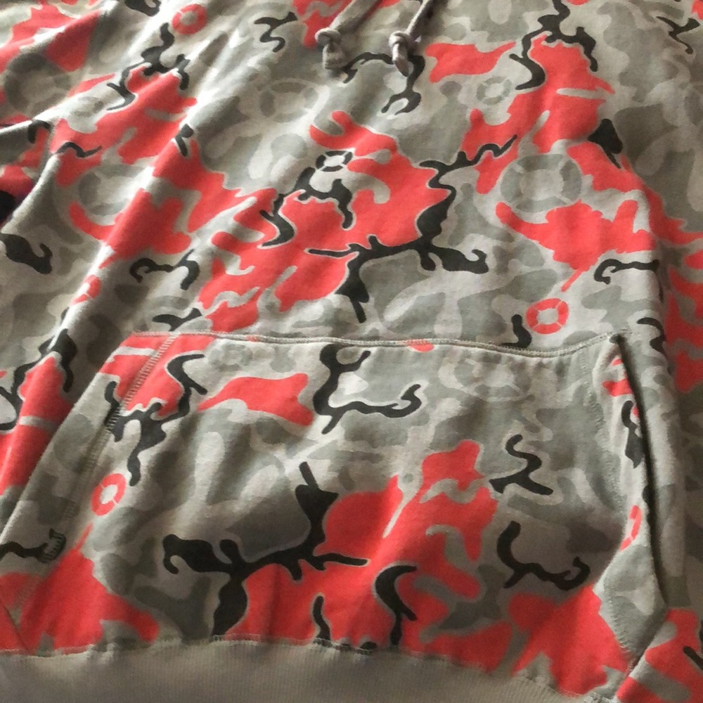 Men’s camouflage print turtleneck hoodie. One large pocket across the front.